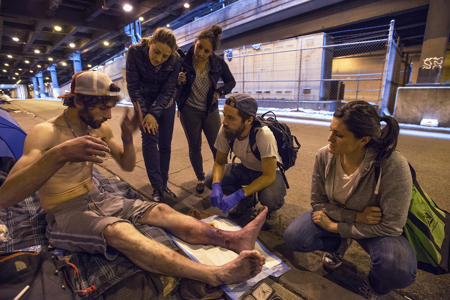 Members of Chicago Street Medicine deliver care to a man who is homeless. (Courtesy of Lloyd DeGrane Photography)
