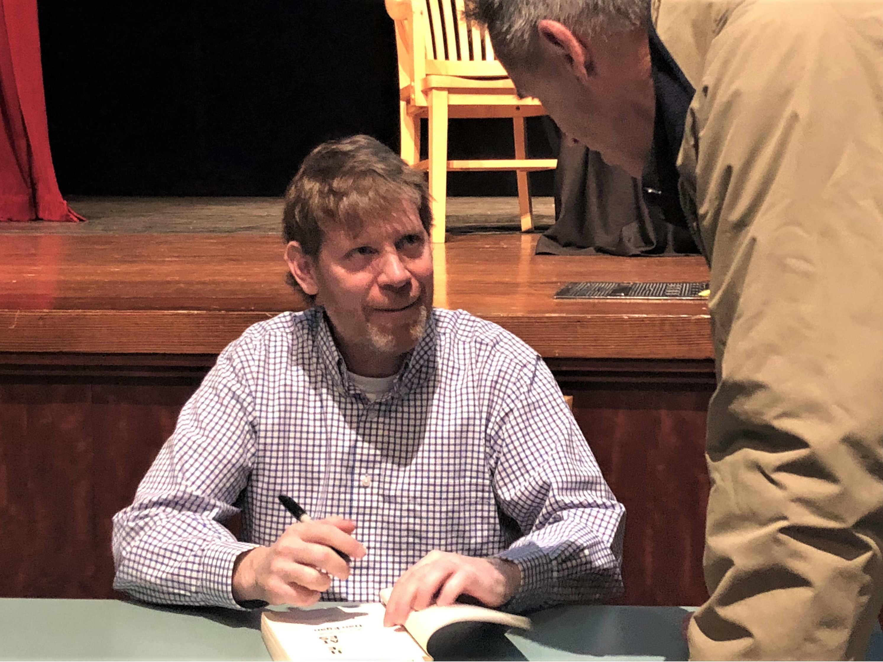 Author Dan Egan signs copies "The Death and Life of the Great Lakes" at a One Book One Chicago event. [WTTW/Patty Wetli]