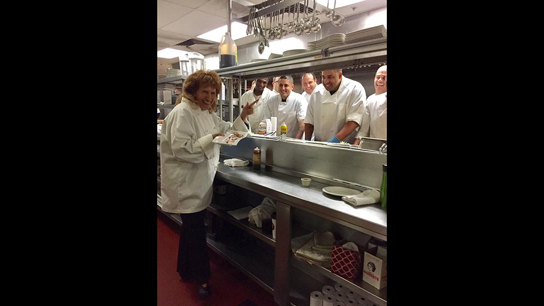 Mimi in the kitchen with residents. (Courtesy of Nan Alexander Doyal)