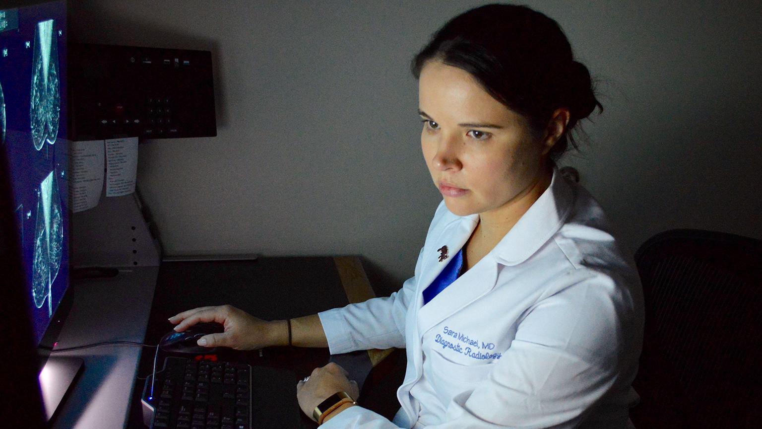 Diagnostic radiologist Maj. Sara Michael reviews a mammogram at Blanchfield Army Community Hospital to look for any abnormalities in the breast tissue. (Photo Credit: Maria Yager)