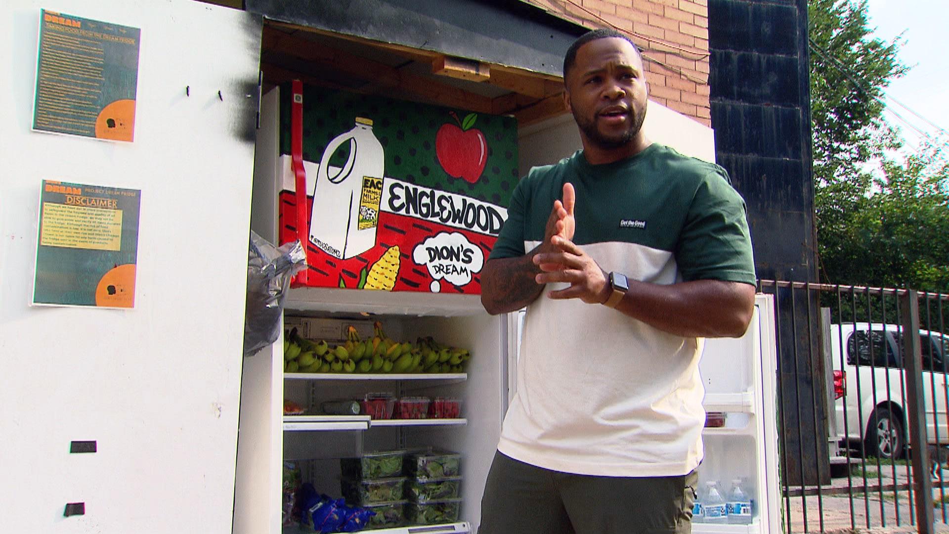 Dion Dawson, founder and executive director of Dion’s Chicago Dream, stands next to the nonprofit’s Dream Fridge. (WTTW News)
