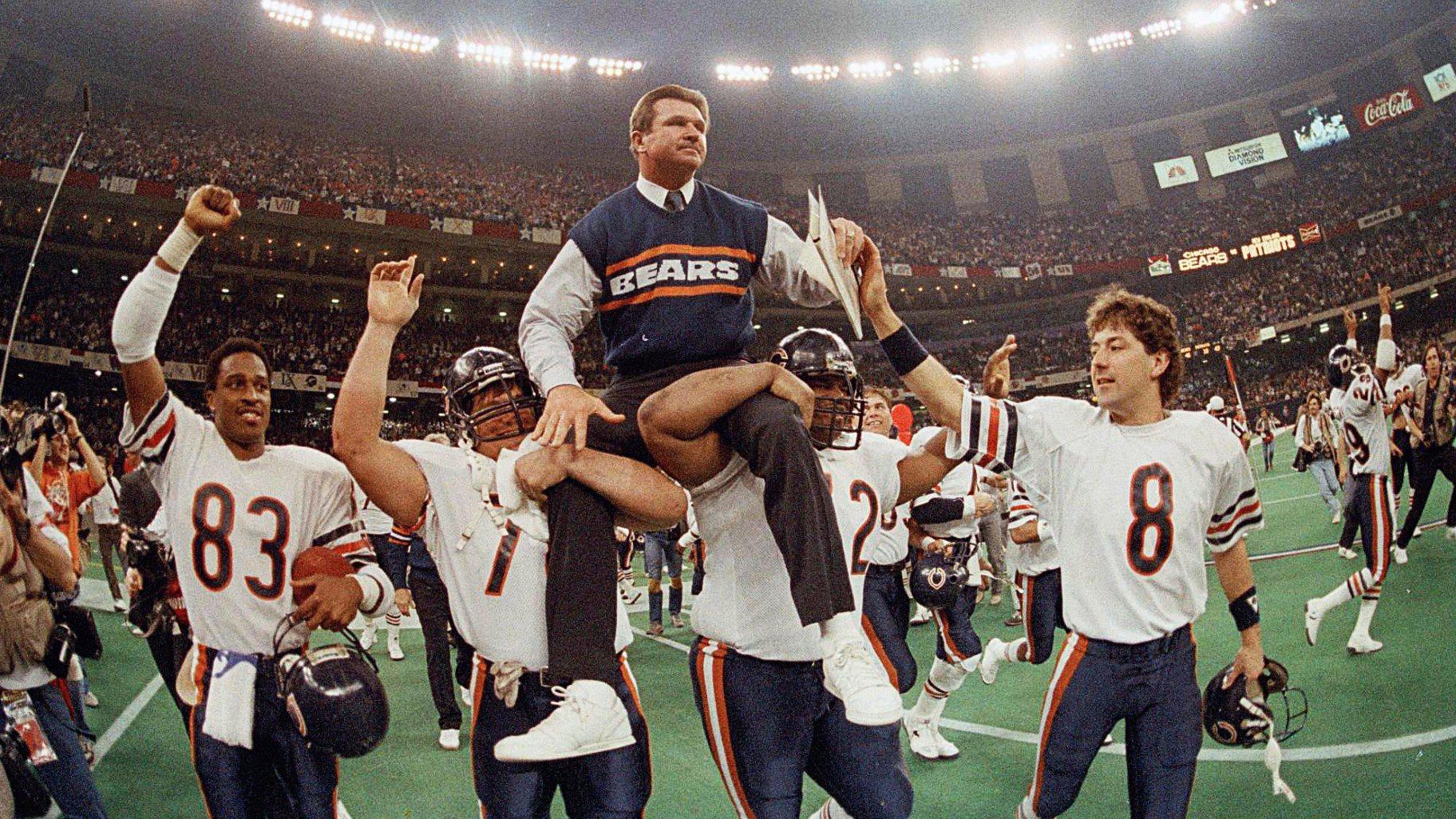 FILE - In this Jan. 26, 1986, file photo, Chicago Bears coach Mike Ditka is carried off the field by Steve McMichael, left, and William Perry after the Bears defeated the New England Patriots 46-10 in NFL football's Super Bowl XX in New Orleans. Willie Gault (83) and Maury Buford (8) join the celebration. (AP Photo / Phil Sandlin, File)