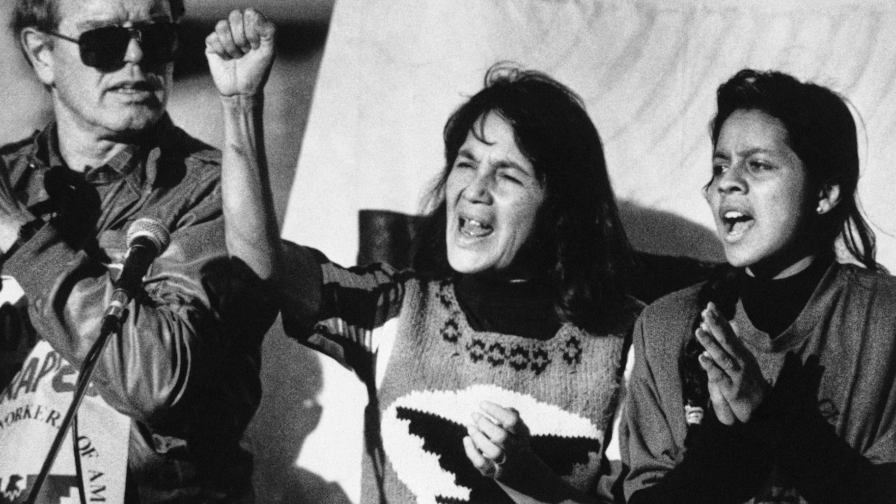 United Farm Workers leader Dolores Huerta, center, leads a rally in San Francisco's Mission District on Nov. 19, 1988, along with Howard Wallace, president of the San Francisco chapter of the UFW, left, and Maria Elena Chavez, 16, the daughter of Cesar Chavez, right, as part of a national boycott of what the UFW claims is the dangerous use of pesticides on table grapes. (AP Photo/Court Mast, File)