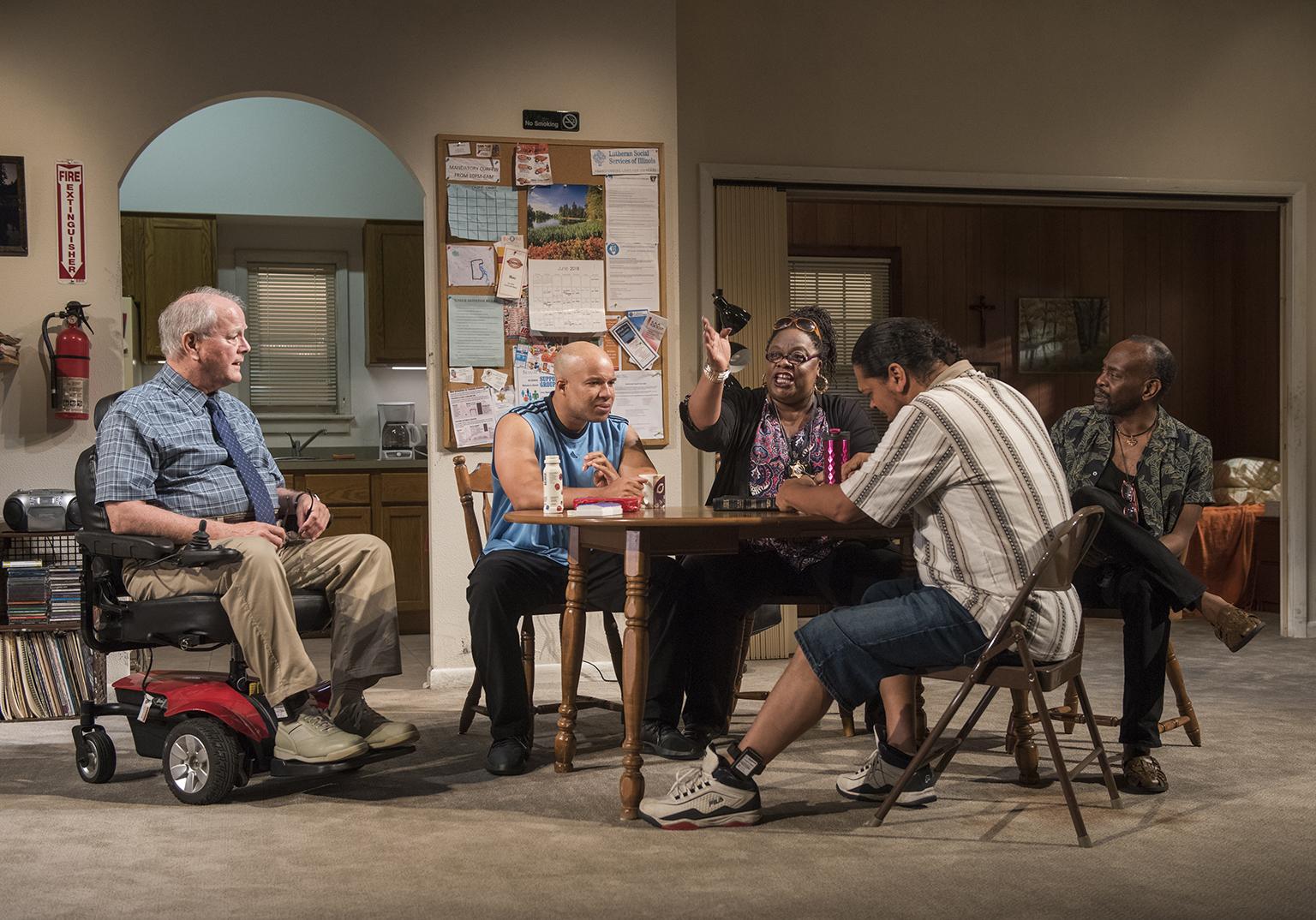 Left to right: Ensemble member Francis Guinan (Fred), ensemble member Glenn Davis (Gio), Cecilia Noble (Ivy), Eddie Torres (Felix) and ensemble member K. Todd Freeman (Dee) in Steppenwolf’s world premiere production of “Downstate.” (Photo by Michael Brosilow)