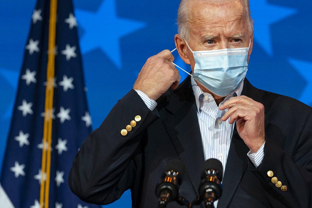 Democratic presidential candidate former Vice President Joe Biden removes his face mask to speak at The Queen theater, Thursday, Nov. 5, 2020, in Wilmington, Del. (AP Photo / Carolyn Kaster)