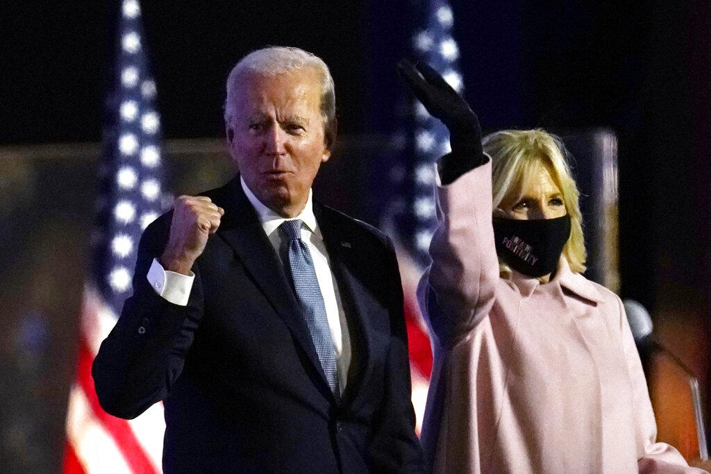 Democratic presidential candidate former Vice President Joe Biden arrives to speak to supporters, early Wednesday, Nov. 4, 2020, in Wilmington, Del., as Jill Biden looks on. (AP Photo / Paul Sancya)