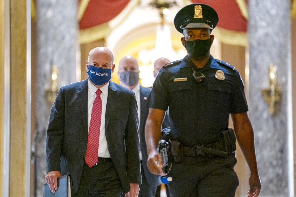 In this Aug. 5, 2020, file photo Postmaster General Louis DeJoy, left, is escorted to House Speaker Nancy Pelosi’s office on Capitol Hill in Washington. (AP Photo / Carolyn Kaster, File)