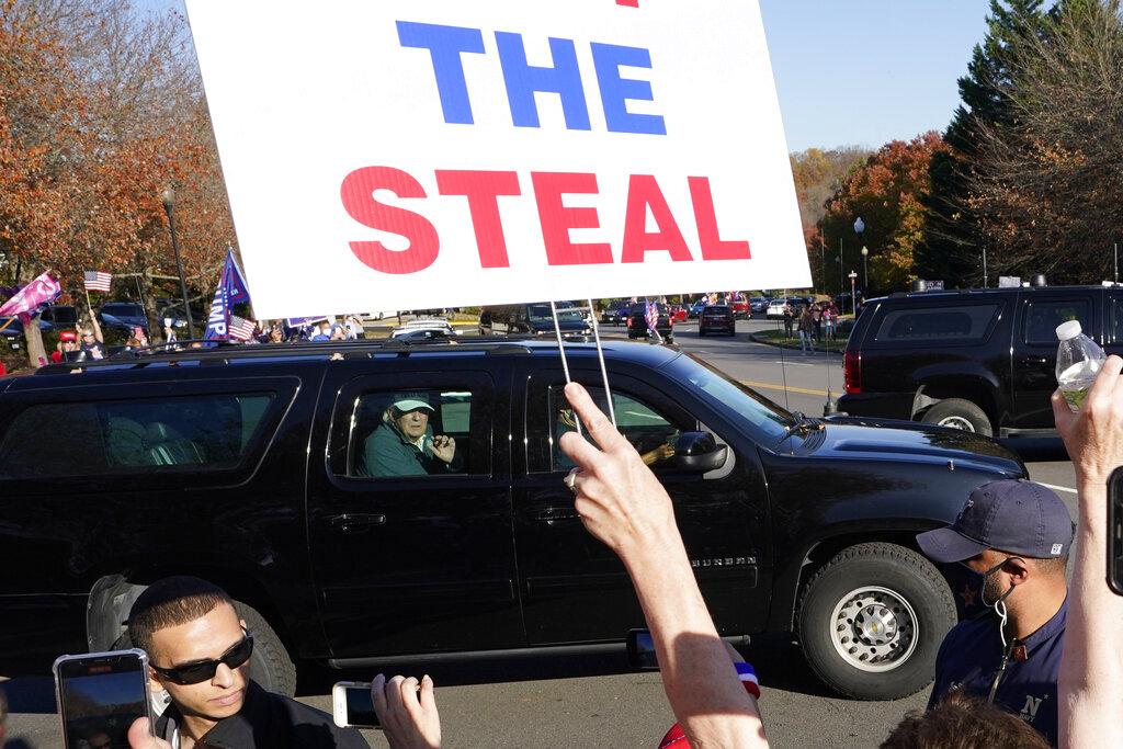 President Donald Trump looks on to supporters after leaving the Trump National golf club in Sterling, Va., Saturday, Nov 7, 2020. (AP Photo / Steve Helber)
