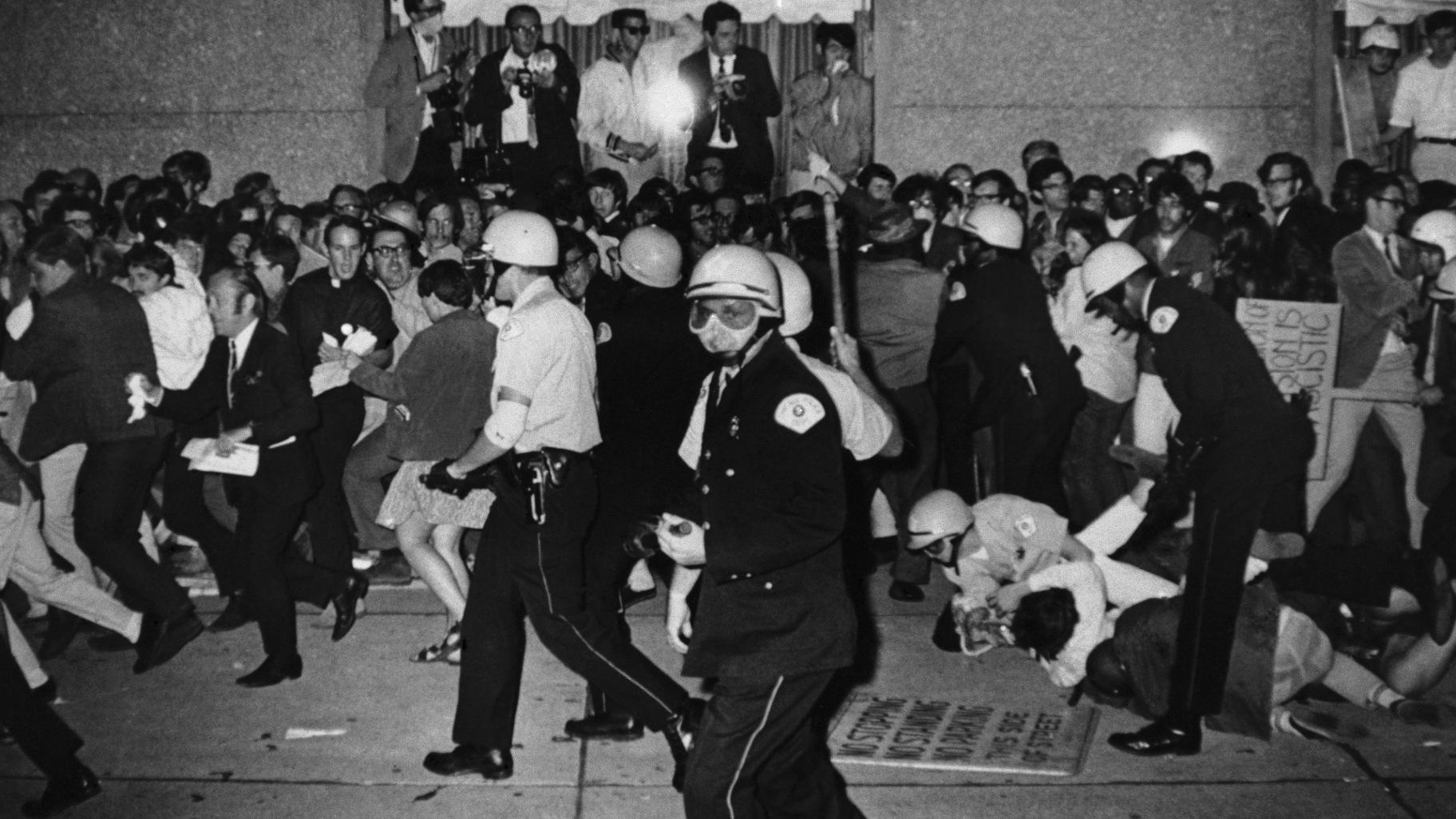FILE - Chicago Police attempt to disperse demonstrators outside the Conrad Hilton, Democratic National Convention headquarters, Aug. 29, 1968, in Chicago. (Michael Boyer / AP Photo, File)