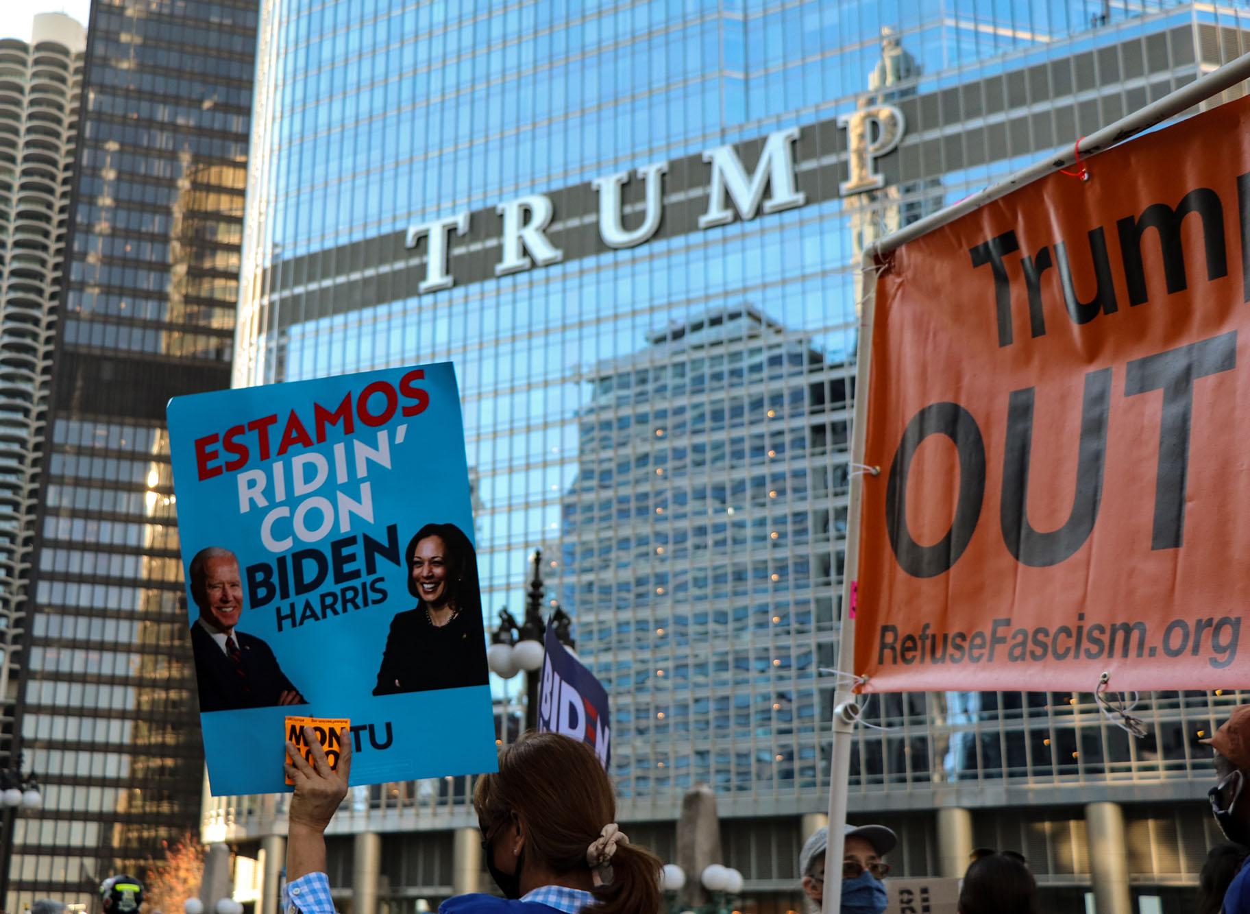 A crowd holds signs near Trump Tower in Chicago on Saturday, Nov. 7, 2020. (Grace Del Vecchio / WTTW News)