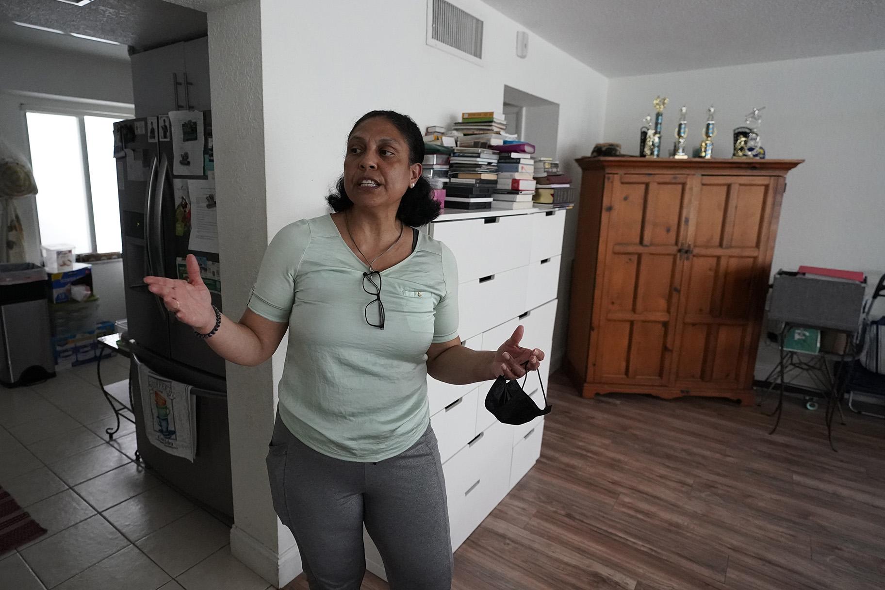 Cristina Livingston recounts the problems she has had in her apartment including a leaking ceiling and mold, Friday, June 18, 2021, at her home in Bay Harbor Islands, Fla. (AP Photo / Wilfredo Lee)