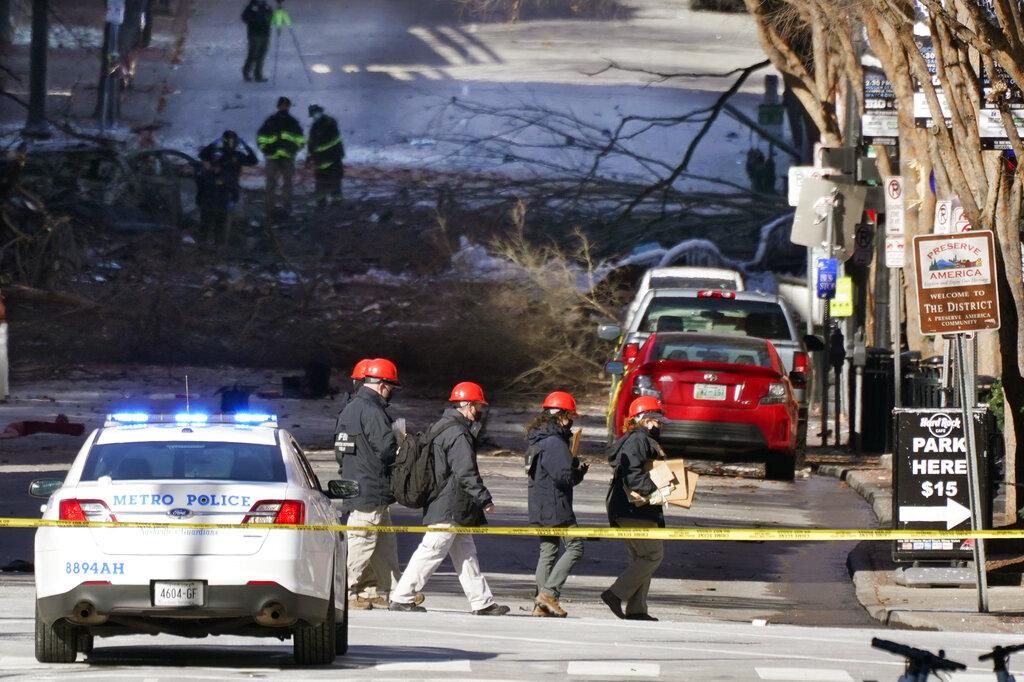 Investigators walk near the scene of an explosion Saturday, Dec. 26, 2020, in Nashville, Tenn. (AP Photo / Mark Humphrey)