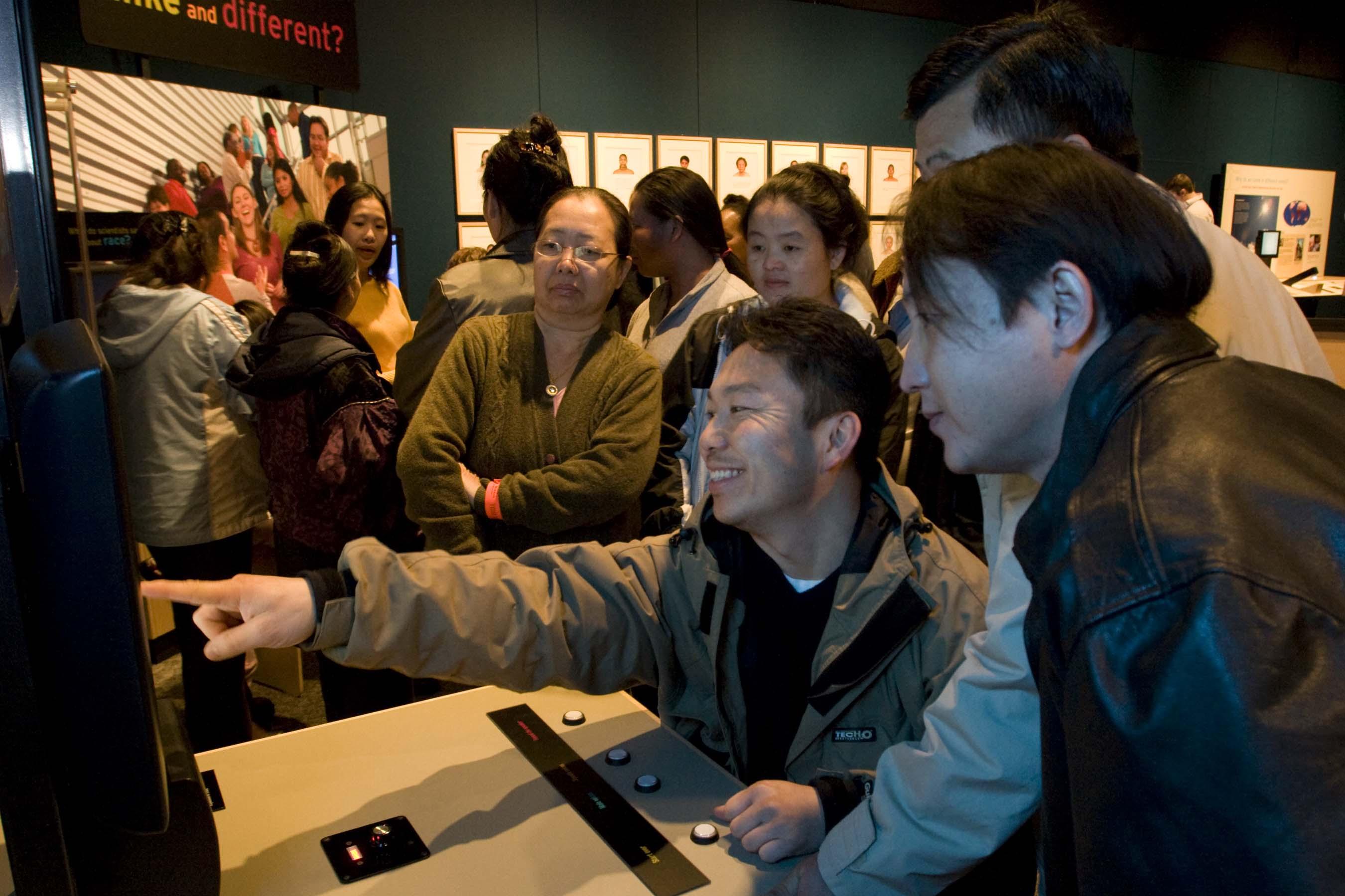 A family listens to voices and tries to match them with pictures of the speakers. (Courtesy of the American Anthropological Association and Science Museum of Minnesota)