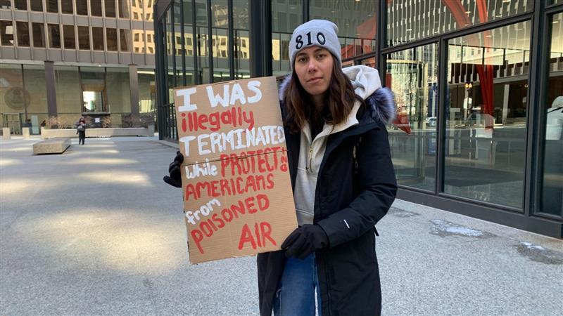 Former EPA employee Nicole Smith poses with a sign following a rally on Feb. 18, 2025. Smith found out via email that she was let go after having been with the agency for two months. (Eunice Alpasan / WTTW News)