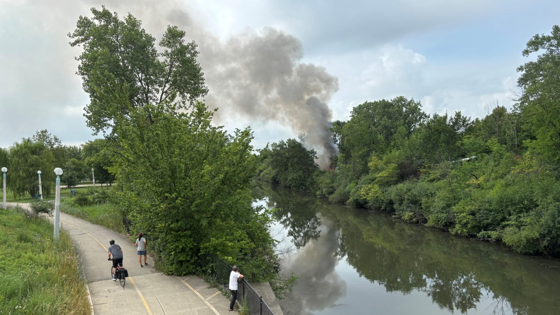A fire broke out in a homeless encampment along the North Shore Channel on July 28, 2025. (Crystin Immel / WTTW News)