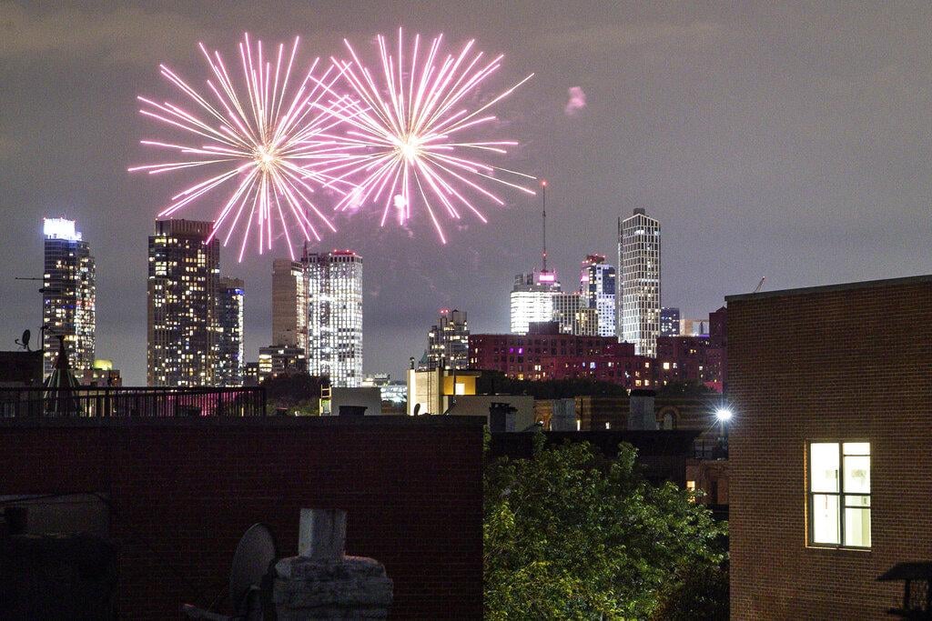 In this Friday, June 19, 2020 photo, fireworks explode during Juneteenth celebrations above the Bedford-Stuyvesant neighborhood in the Brooklyn borough of New York. (AP Photo / John Minchillo, File)