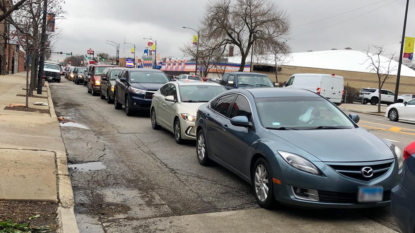 The line of cars waiting for free gas, March 24, 2022, on Western Avenue, stretching from Irving Park Road south past Addison Street. (Patty Wetli / WTTW News) 