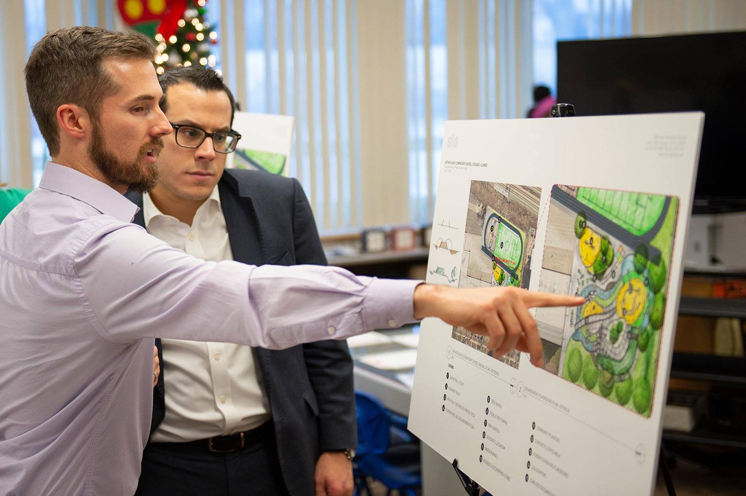 Project Manager Justin Rossman of Site Design Group explains the highlights of Ashe Elementary School’s planned garden to Dean Alonistiotis, aide to MWRD Commissioner Kimberly Du Buclet. (Courtesy Metropolitan Water Reclamation District of Greater Chicago)