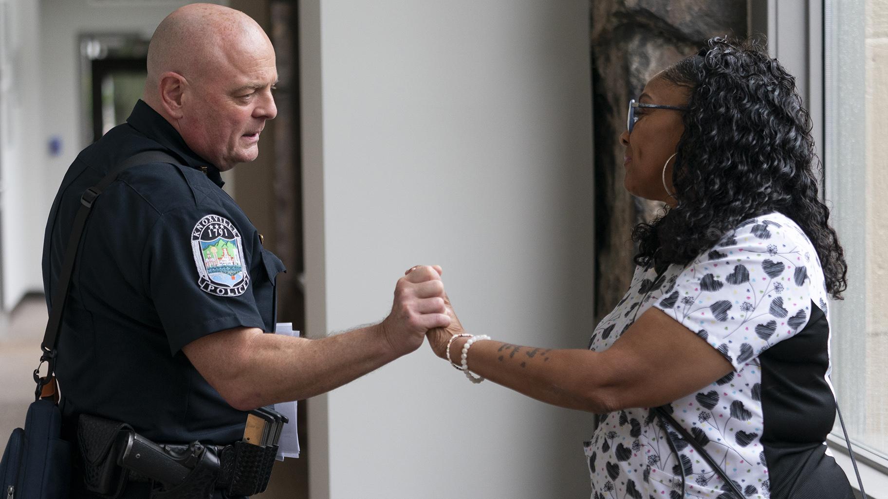 Knoxville Deputy Police Chief Tony Willis talks with Terry Walker-Smith after a meeting of the Violence Reduction Leadership Committee on Thursday, Aug. 3, 2023, in Knoxville, Tenn. The city saw a spike in gun deaths in 2020 and 2021, with a gun homicide rate that at one point in 2021 rivaled Chicago’s. (AP Photo / George Walker IV)