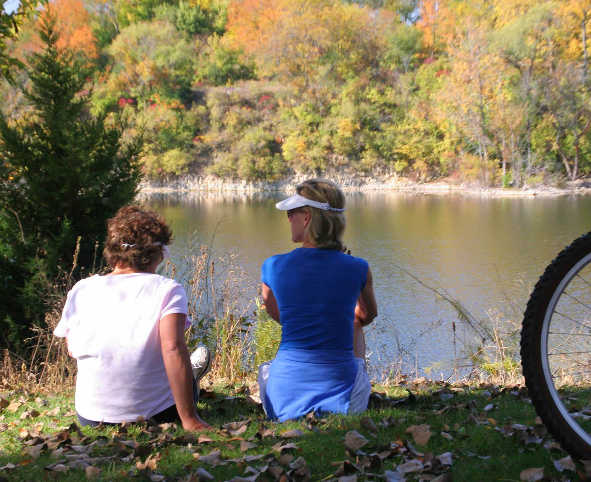 Bicyclists enjoy a relaxing break overlooking the quarry lake at Headquarters Forest Preserve which is the trailhead for the Rock River Recreation Path. (Photo by Jamie B. Johannsen)