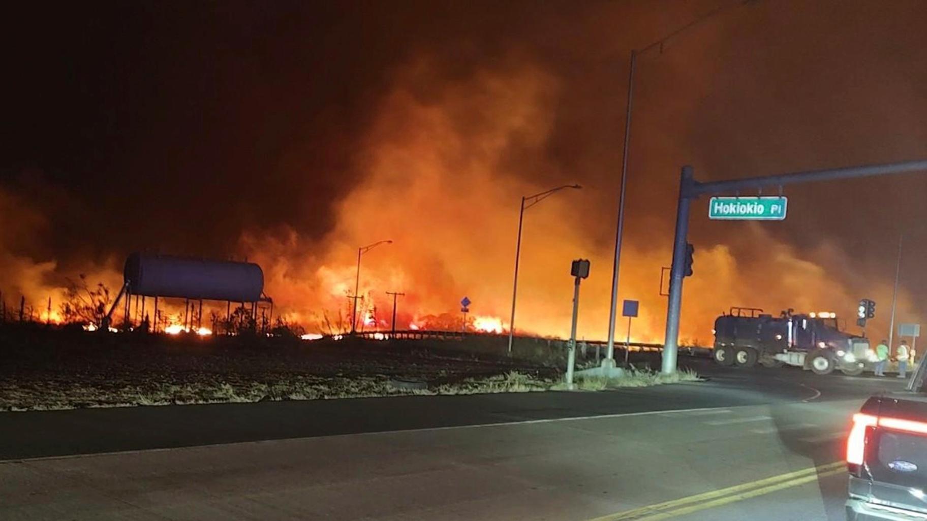 This photo provided by County of Maui shows fire and smoke filling the sky from wildfires on the intersection at Hokiokio Place and Lahaina Bypass in Maui, Hawaii on Tuesday, Aug. 8, 2023. (Zeke Kalua / County of Maui via AP)