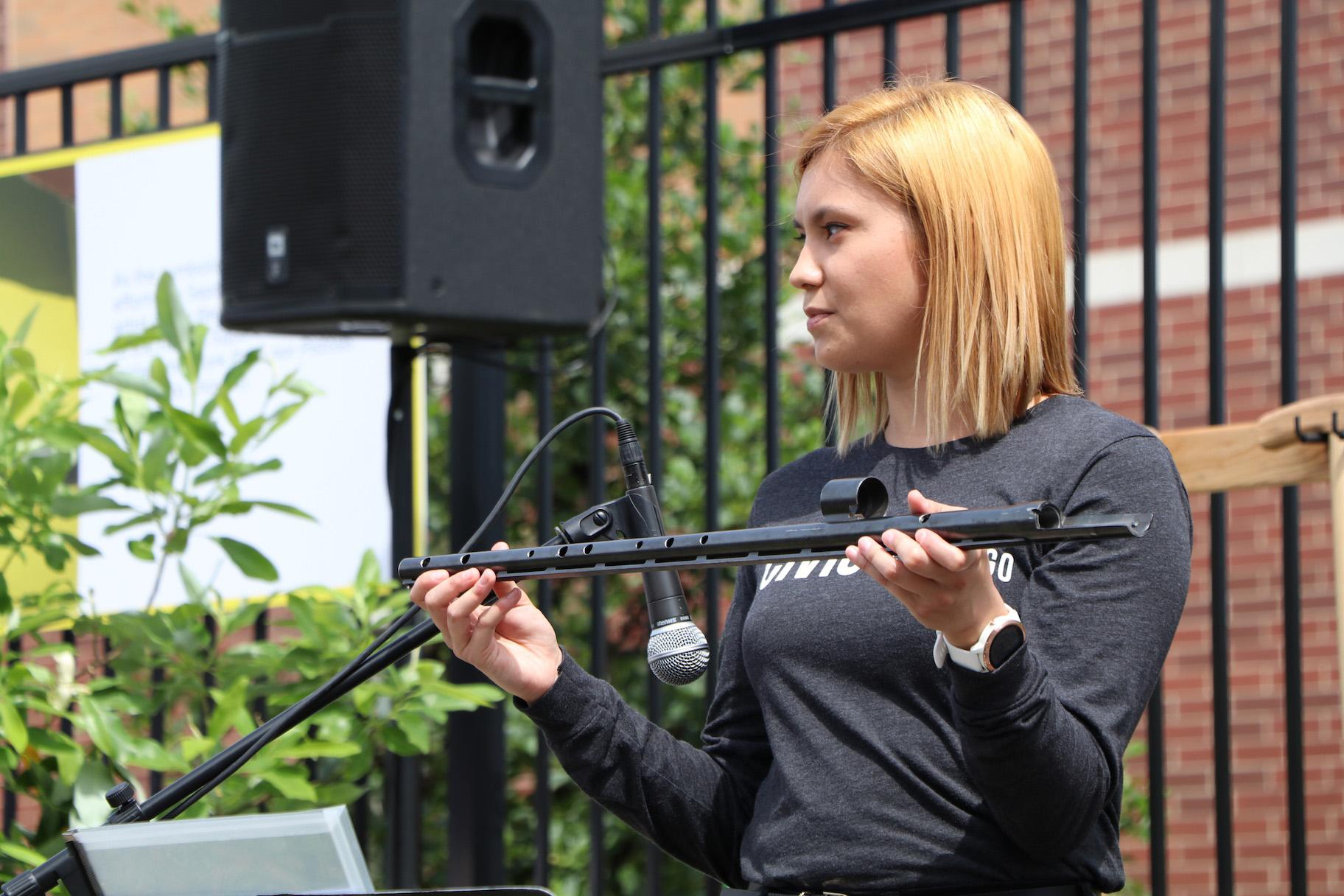 Alexandria Hoffman holds a flute made from a rifle’s barrel. (Evan Garcia / WTTW)