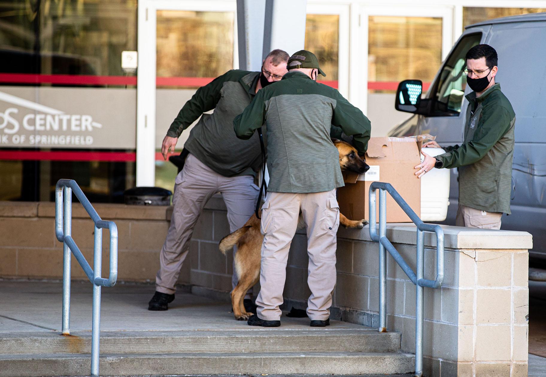 The Illinois State Police use a dog to check containers being delivered to the Bank of Springfield Center during the lame-duck session for the Illinois House of Representatives, Tuesday, January 12, 2021, in Springfield. (Justin L. Fowler / The State Journal-Register / Pool)