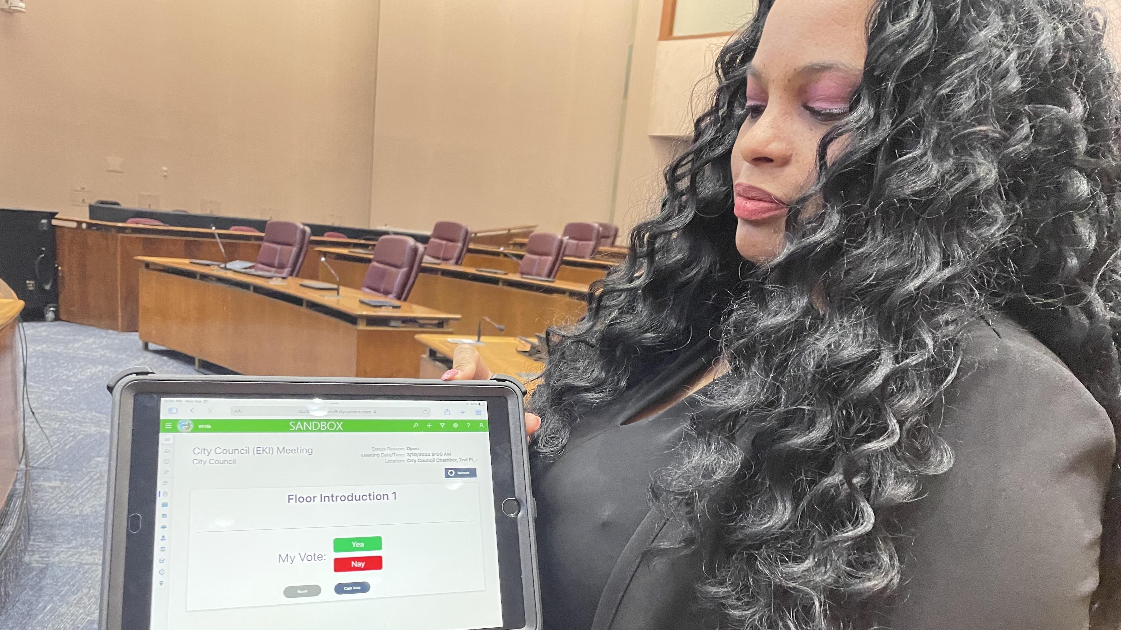 Lawanda Crayton, the chief technology officer for the city clerk's office, displays the voting screen members of the Chicago City Council will see as part of the new electronic voting system on Monday, March 21, 2022. (Heather Cherone/WTTW News)