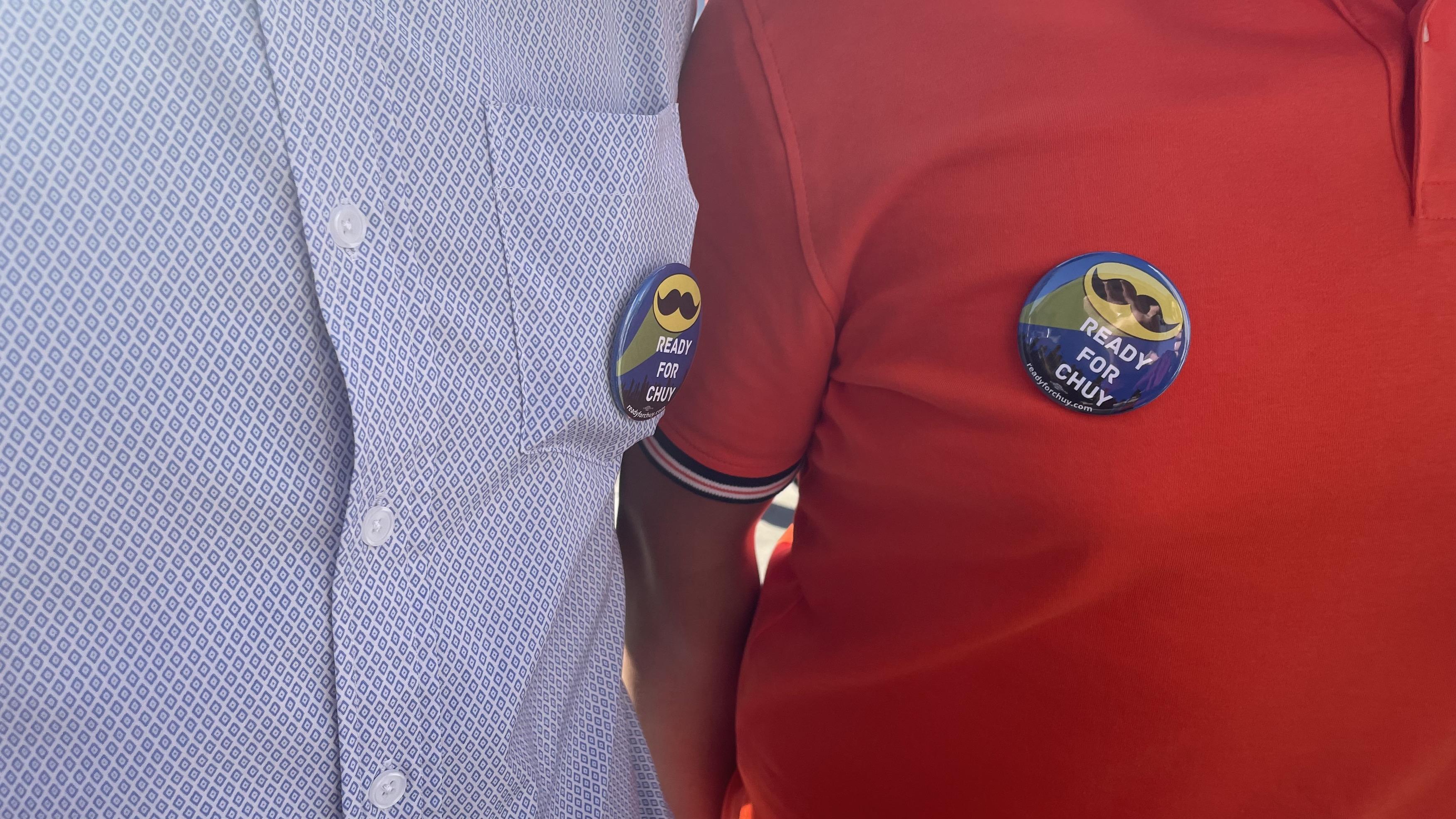 Supporters wearing campaign button's emblazoned with U.S. Rep. Jesus "Chuy" Garcia's famous mustache. (Heather Cherone/WTTW News)