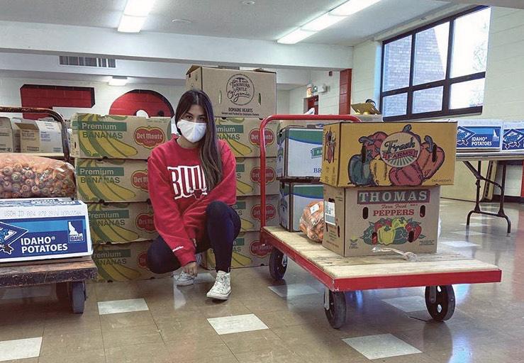 Elizabeth Morales, founder of Del Dia Chicago, sits with boxes of fresh produce she gets every week from farmers and grocery stores. (Courtesy Elizabeth Morales)