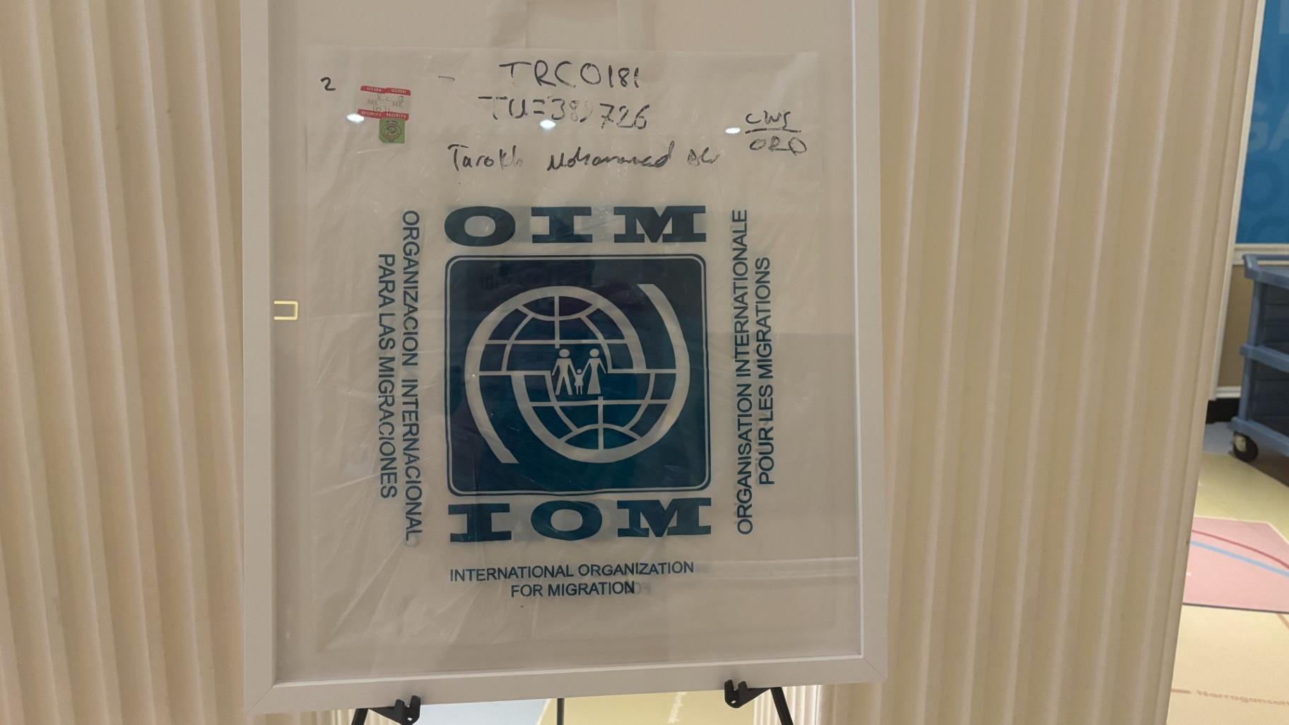 “My IOM Bag – What I Carried With Me” by Ali Tarokh. At “Voices Through Art” on Aug. 20, 2026, Tarokh displayed the bag he received from the International Organization for Migration when he first arrived in the United States. (Shelby Hawkins / WTTW News)