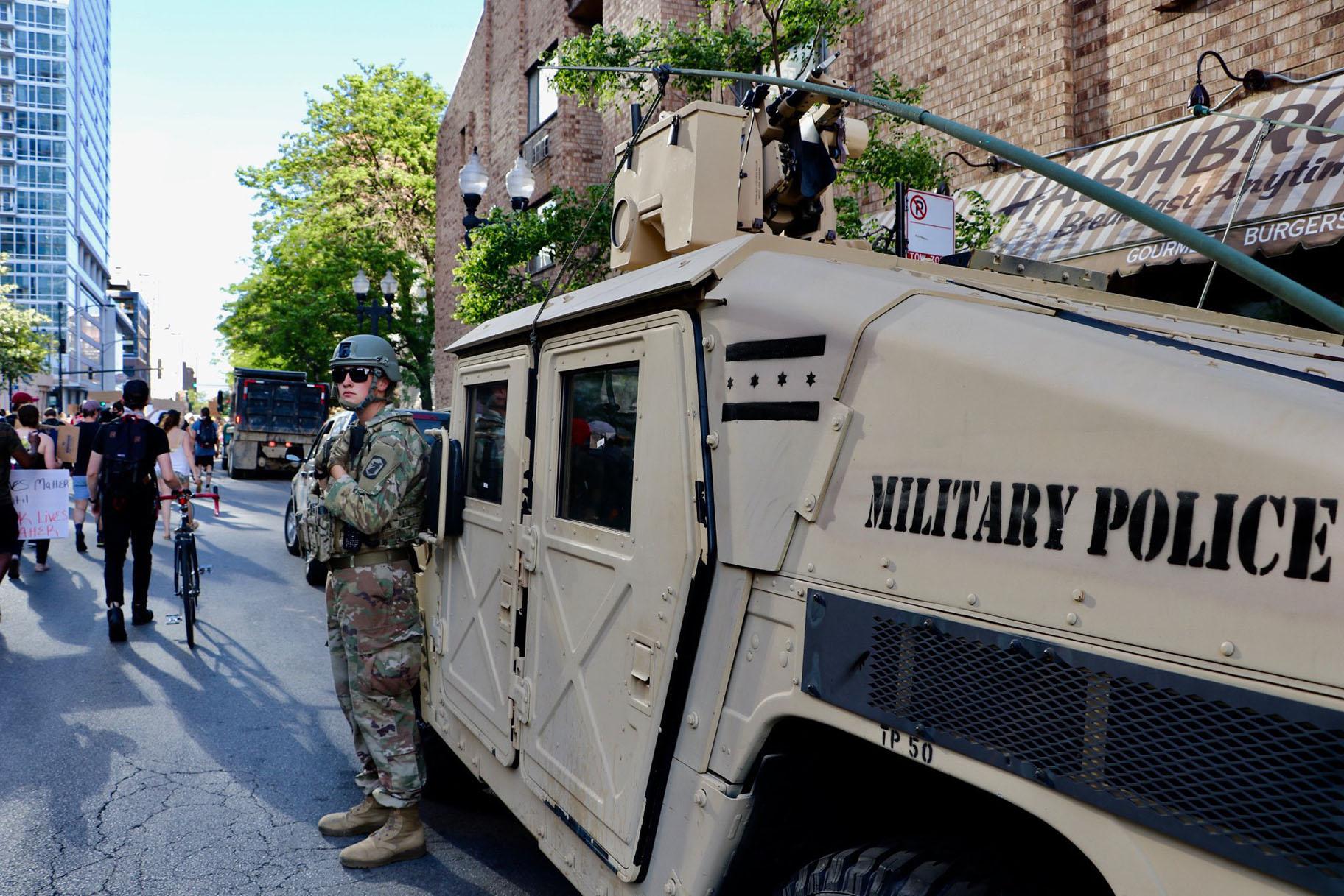 An Illinois National Guard officer watches a protest along Wells Street on June 6, 2020. The march was one of many in the city and across the U.S. sparked by the death of George Floyd while in Minneapolis police custody. (Evan Garcia / WTTW News)