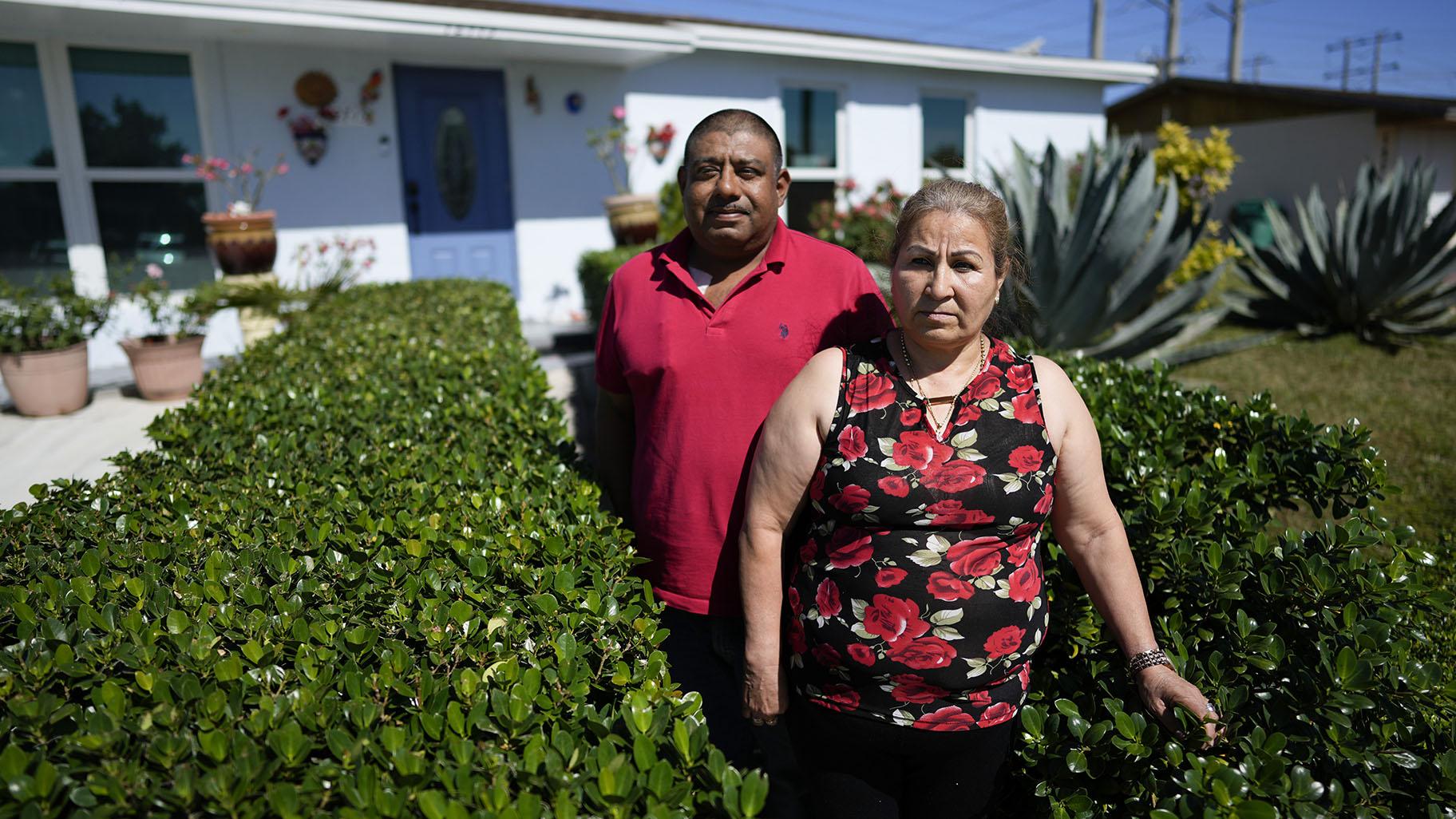 Rosalinda Ramirez, 57, and her partner Jose Guerrero, 41, Mexican immigrants who crossed the border separately over two decades ago and who have built lives and he a landscaping business in the U.S. but never found a route to obtain legal status, pose for a picture outside their home in Homestead, Fla., Tuesday, Nov. 7, 2023. (AP Photo / Rebecca Blackwell)