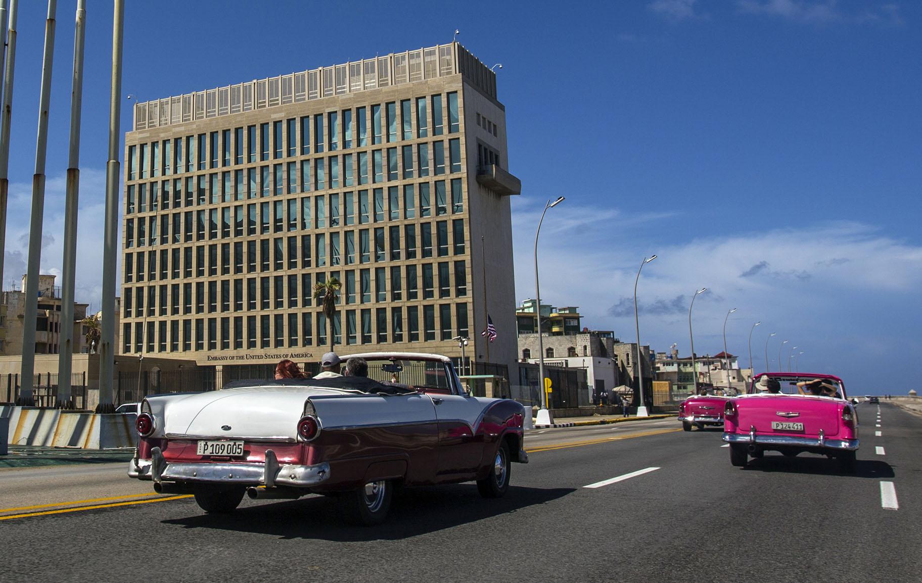 In this Oct. 3, 2017, file photo, tourists ride classic convertible cars on the Malecon beside the United States Embassy in Havana, Cuba. (AP Photo / Desmond Boylan, File)