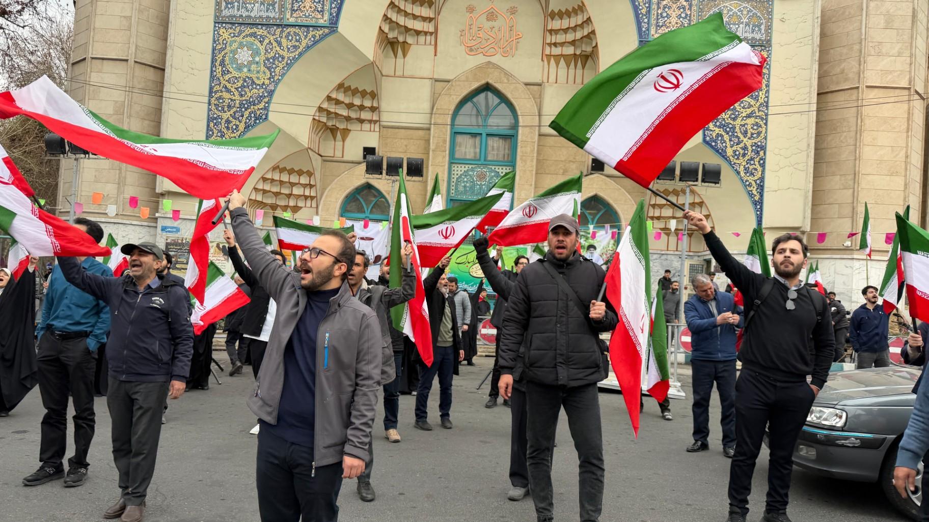 A group of men wave Iranian flags as they attend a demonstration in support of the government and against U.S. and Israeli strikes in Tehran, Iran, Saturday, Feb. 28, 2026. (AP Photo / Vahid Salemi)