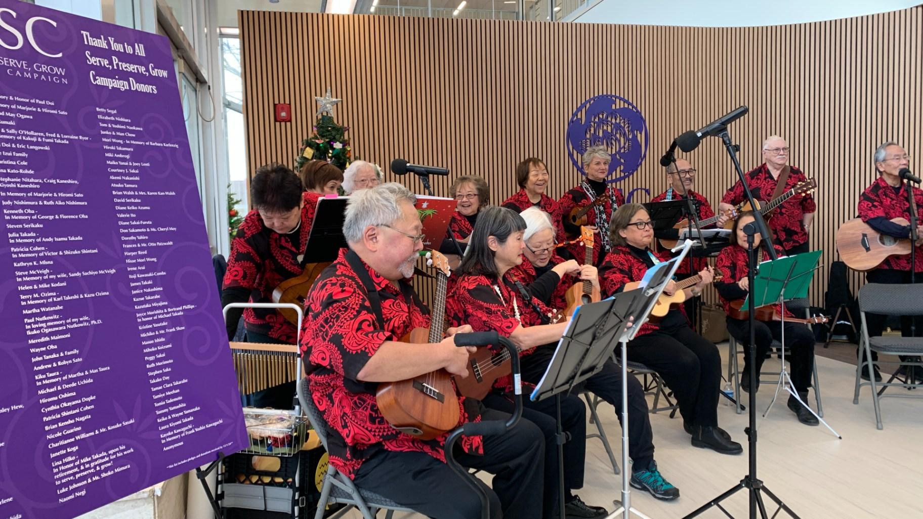 Musical performance in the main lobby of the Japanese American Service Committee’s new building on Dec. 12, 2024. (Eunice Alpasan / WTTW News)