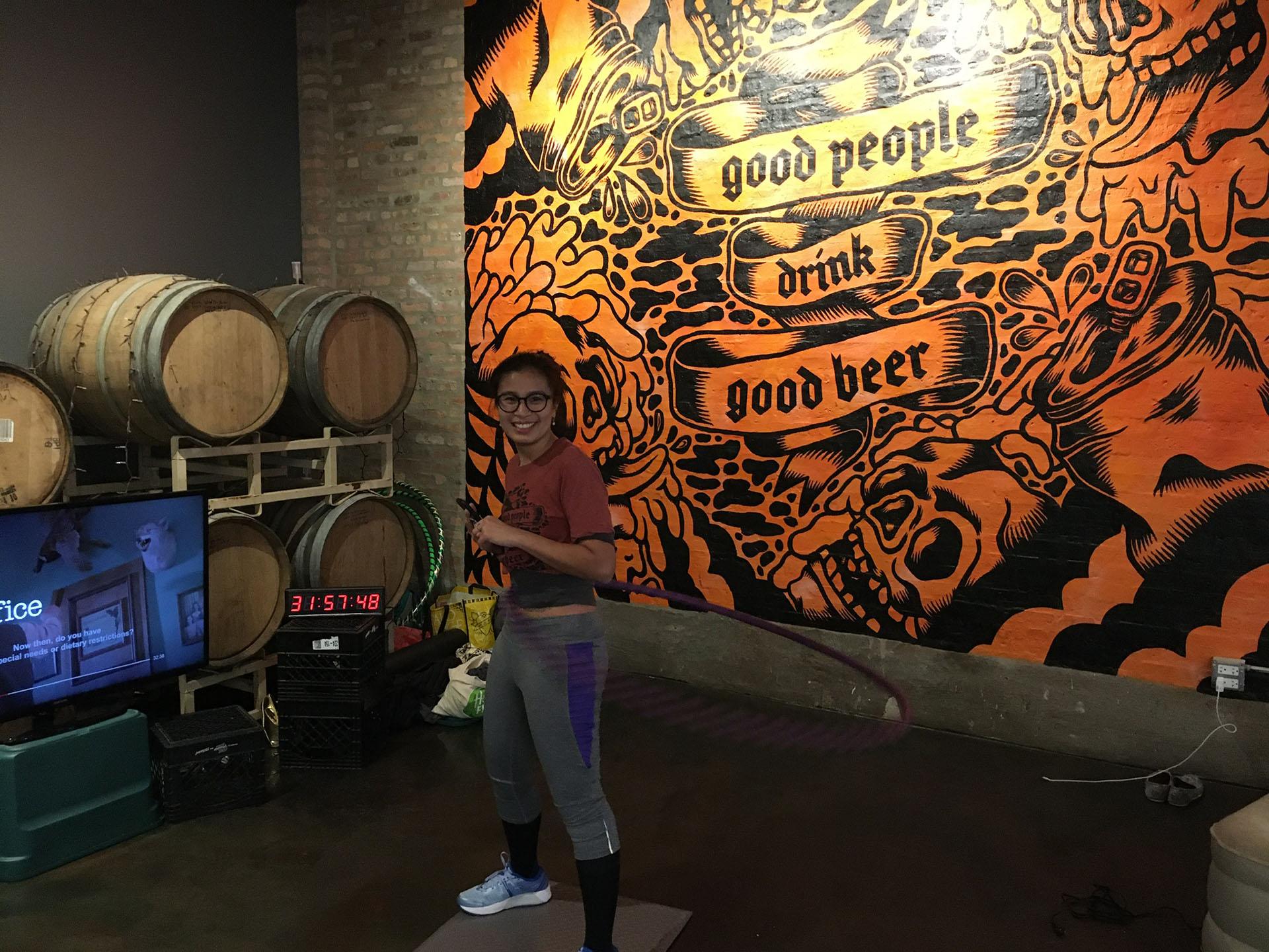 Wicker Park resident Jenny Doan hula-hoops at District Brew Yards. (Kristen Thometz / WTTW News)