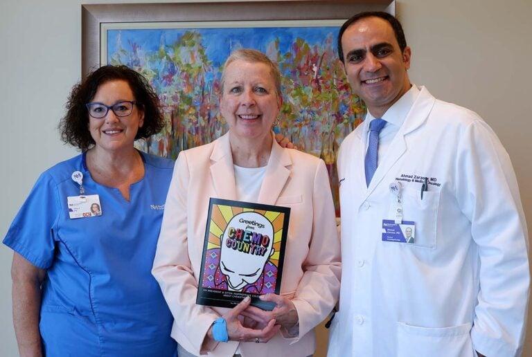 Wheaton resident Jeri Davis (center) poses for a picture with her chemotherapy nurse Amy Forde (left) and Dr. Ahmad Zarzour. (Photo by Michelle Green)