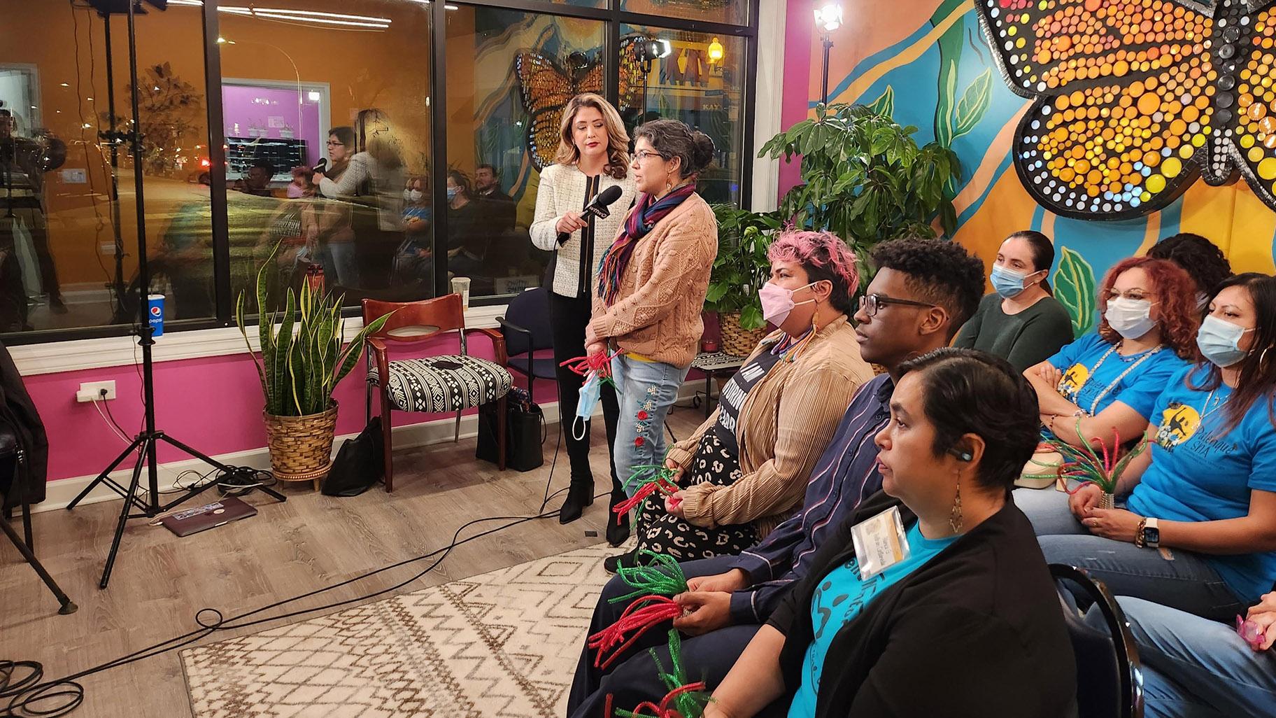 WTTW News correspondent Joanna Hernandez interviews a viewer during the WTTW News Mayoral Forum watch event at Palenque LSNA in Logan Square. (Acacia Hernandez / WTTW News)