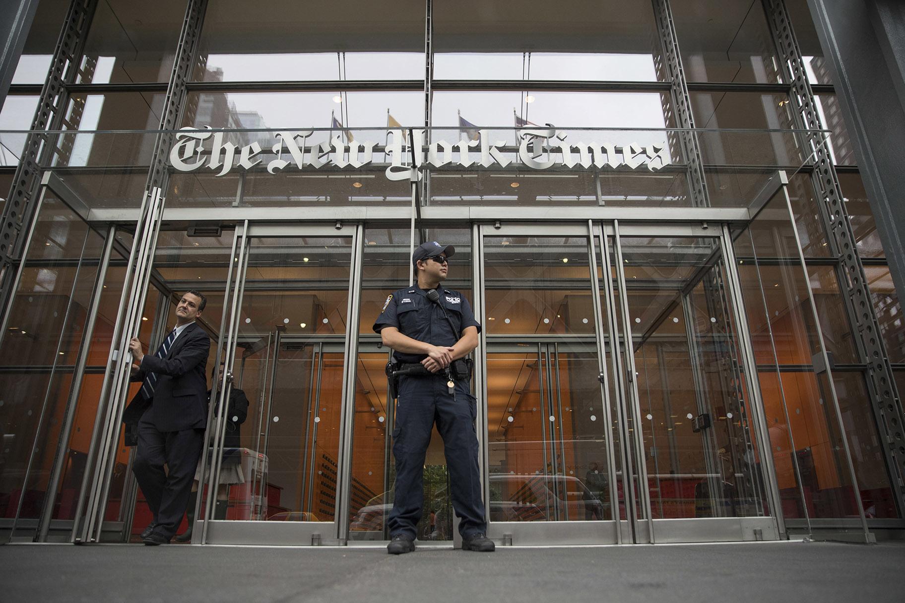 In this June 28, 2018, file photo, a police officer stands outside The New York Times building in New York. (AP Photo / Mary Altaffer, File)