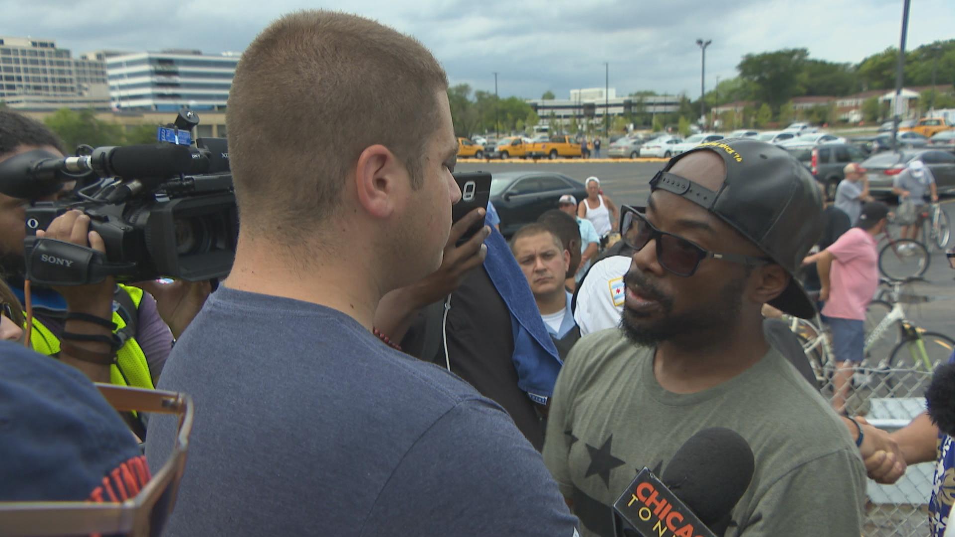 Protester Brian Blaze Roberts, right, of Woodland, challenges a man at the protest who said he does not live in Chicago.