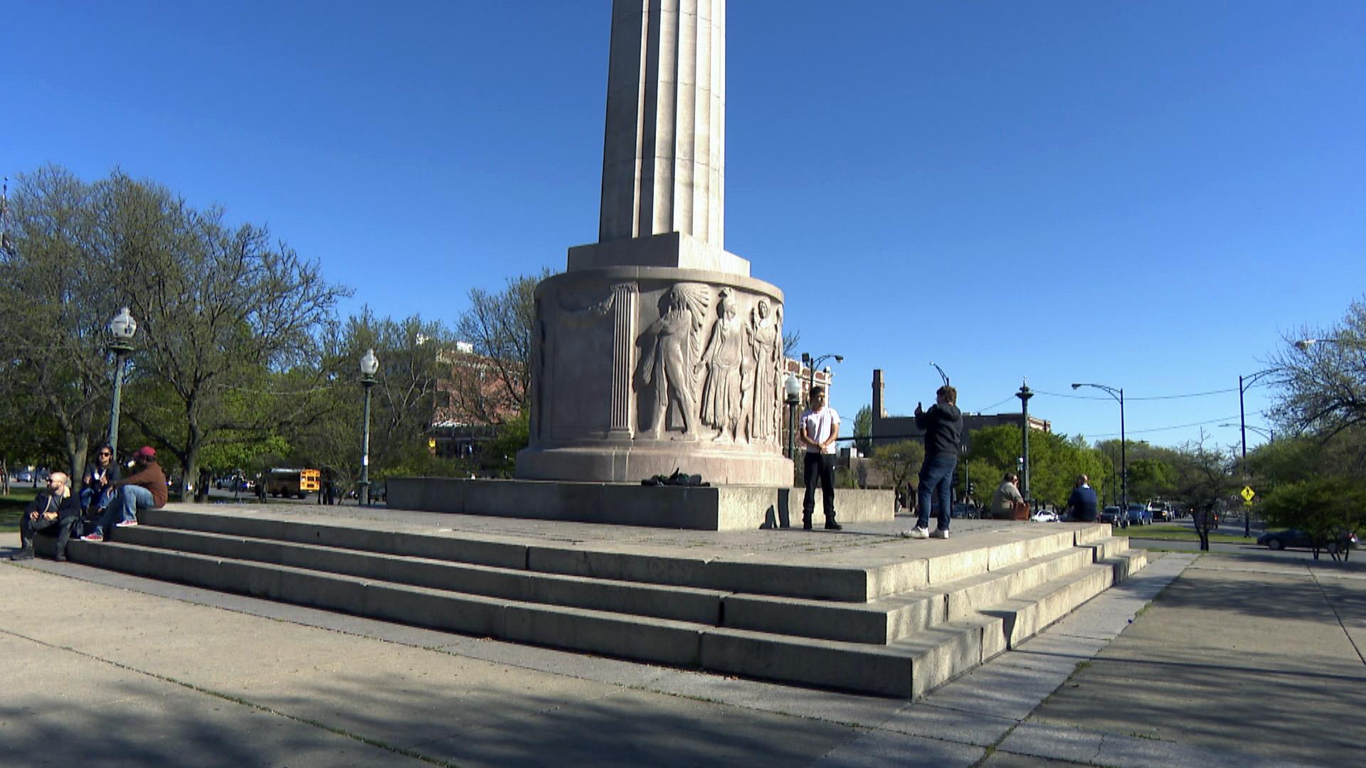 Visitors to Logan Square Park congregate near the Illinois Centennial Monument on April 30, 2021. The Logan Square Farmers Market has taken place adjacent to this park from May to October every year since 2005. (WTTW News)