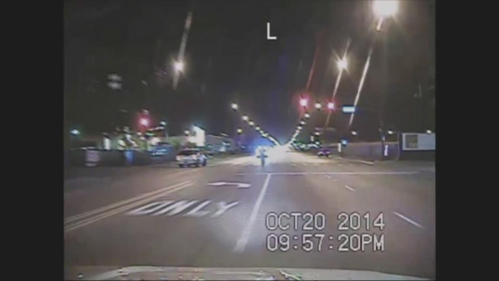 A still image from police dashcam footage that captured the shooting of Laquan McDonald, center, on a Southwest Side street in 2014.