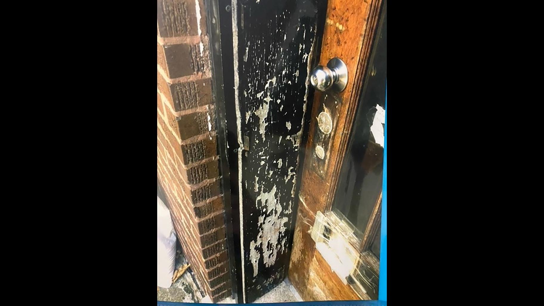 A door with chipped paint is pictured at the former Belmont Cragin residence of 2-year-old Jedi Ruzicka. (WTTW News)