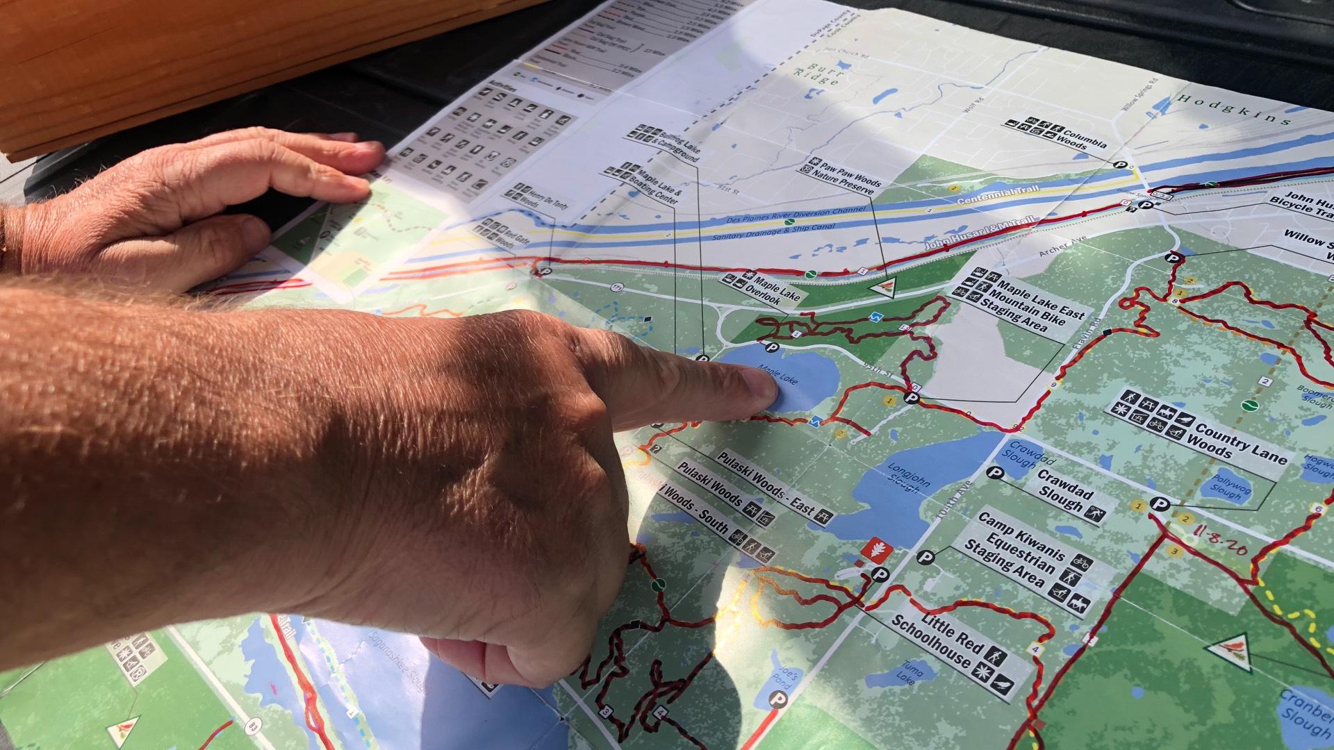 Liam Durnan's trail maps, with completed hikes marked in red. (Patty Wetli / WTTW News)