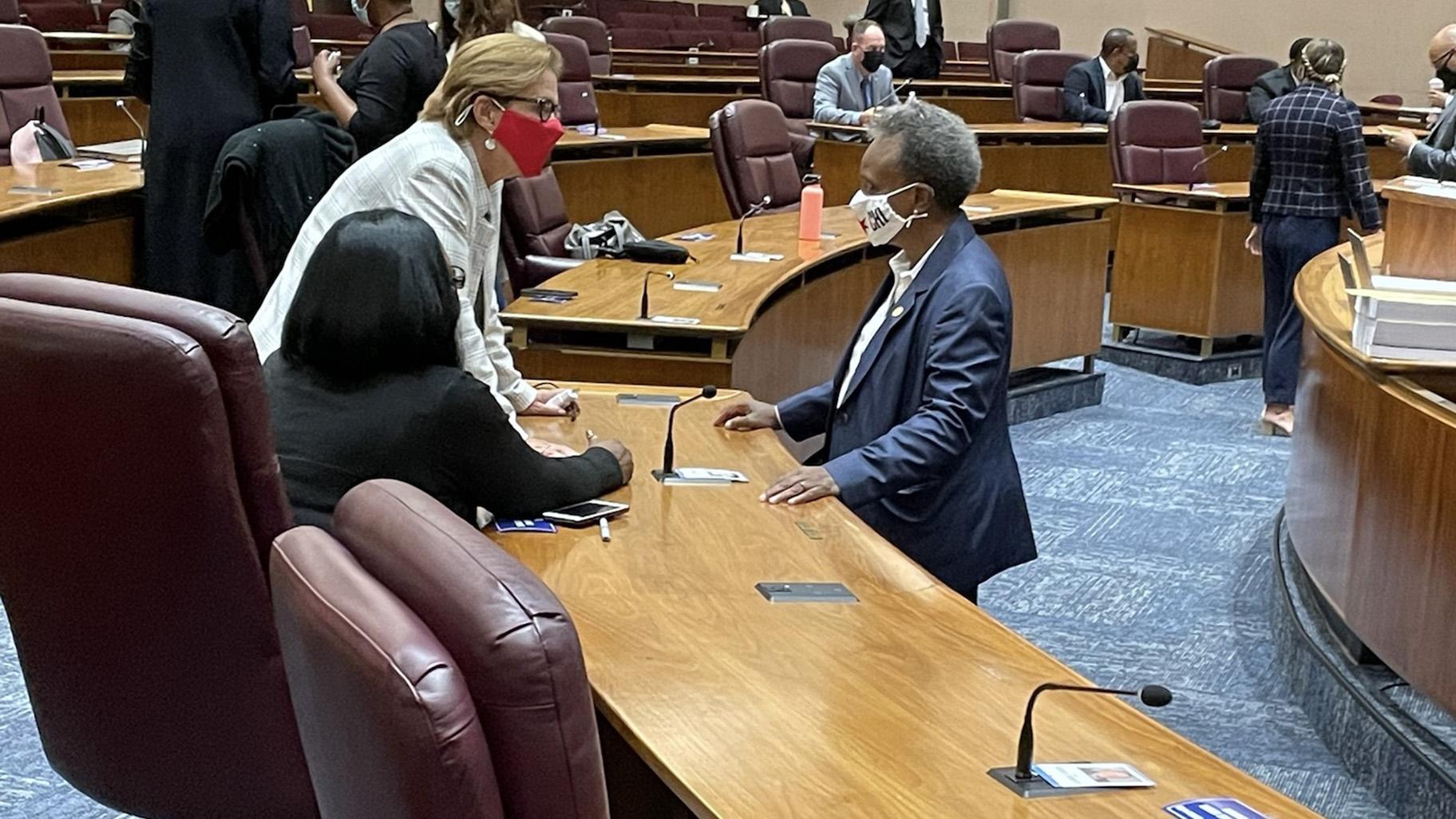 Mayor Lori Lightfoot speaks with Alds. Susan Sadlowski Garza (10th Ward) and Emma Mitts (37th Ward) before detailing her 2022 spending plan on Monday, Sept. 20, 2021. (Heather Cherone / WTTW News)