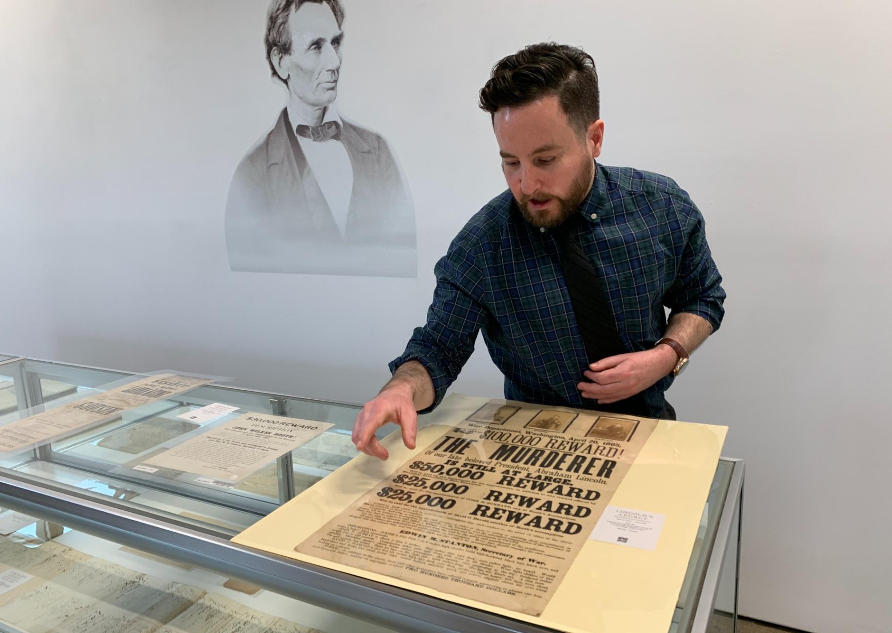Joshua McCracken, associate cataloguer and department coordinator for books and manuscripts at Freeman’s and Hindman, talks on May 19, 2025, about one of the items up for auction from a collection chronicling Abraham Lincoln’s personal and political life. (Eunice Alpasan / WTTW News)