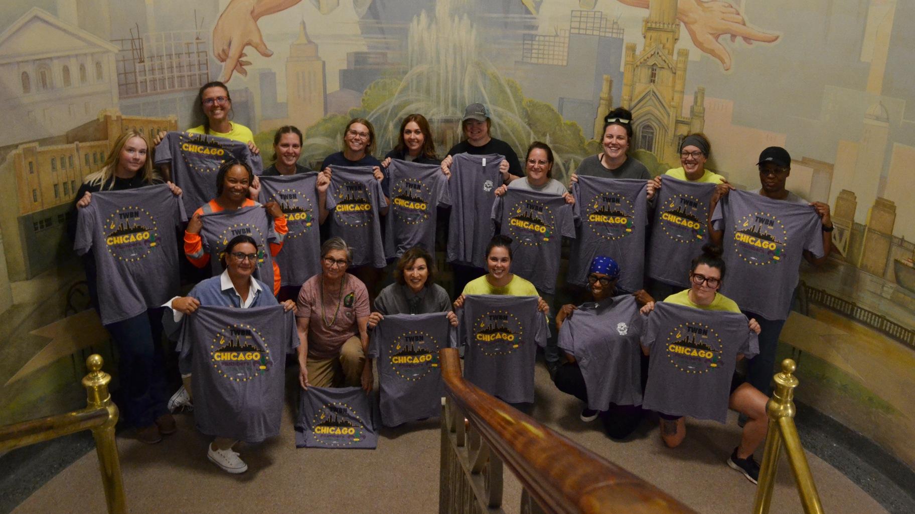 Female members of Plumbers Local Union 130 attend a send-off event in the West Loop on Sept. 19, 2024, ahead of heading to New Orleans to attend Tradeswomen Build Nations, one of the largest conferences for women in construction. (Eunice Alpasan / WTTW News)
