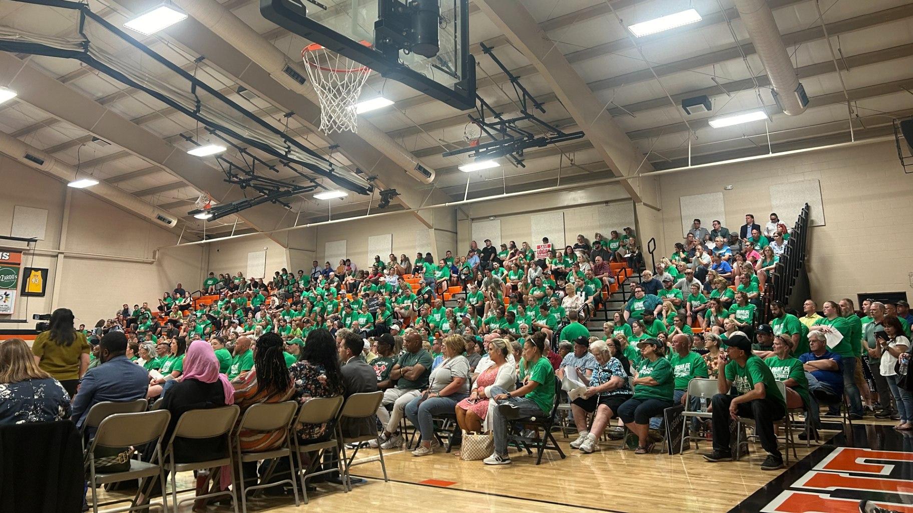 Hundreds of Logan Correctional Center workers and supporters gather at the Lincoln Junior High School, 208 Broadway St., Lincoln, Ill., on Thursday, June 13, 2024, to protest the proposed relocation of the prison. (Blair Paddock / WTTW News)