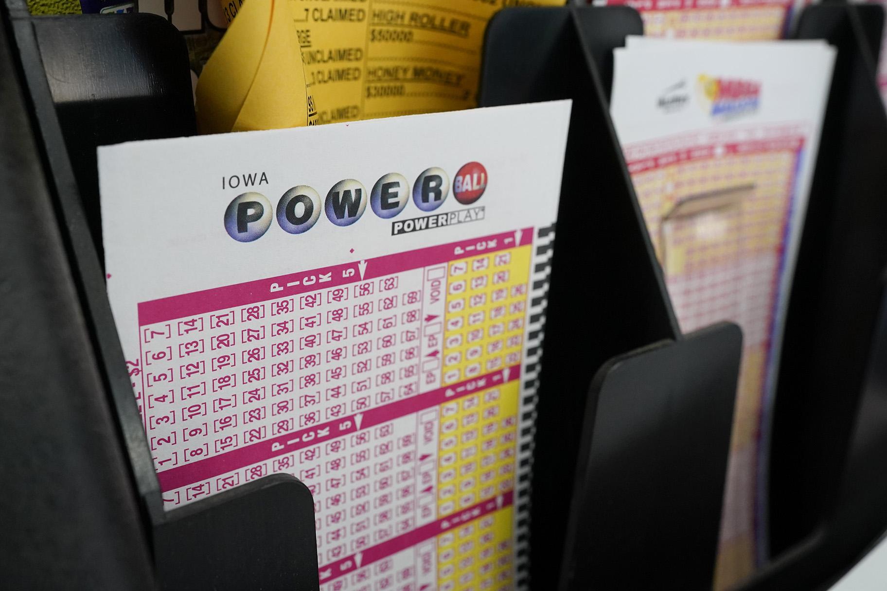 In this file photo from Jan. 12, 2021, blank forms for the Powerball lottery lie in a trash can at a local grocery store in Des Moines, Iowa.  (AP Photo / Charlie Neibergall)